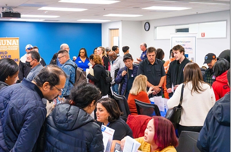 Visitors meeting apprenticeship organizations at a career fair