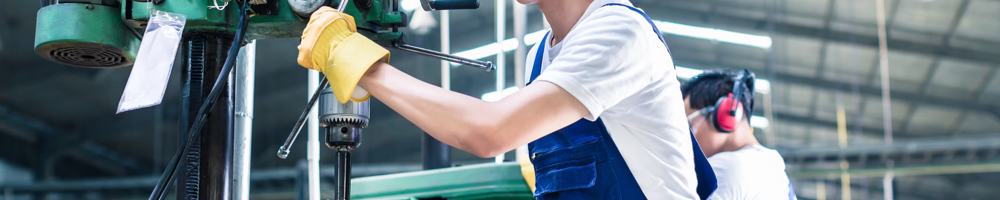 Apprentice working with manufacturing equipment